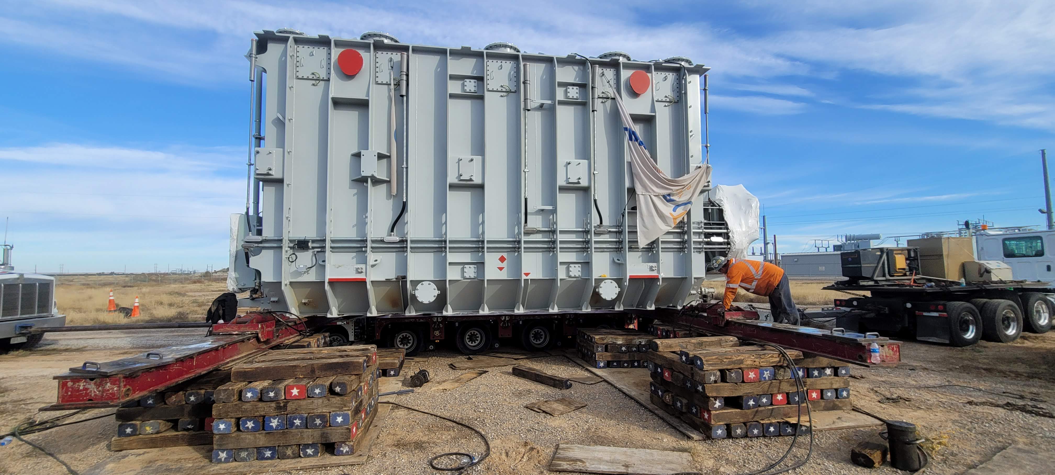 Truck with a trailer platform transports equipment with an elevator car platform